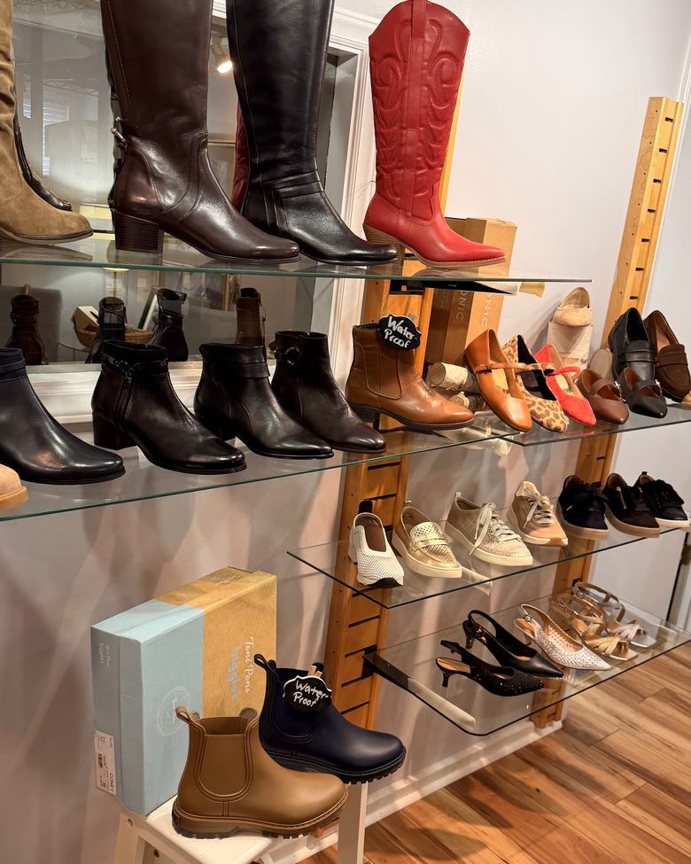 Tall boots, Chelsea boots and flats on the shoe wall