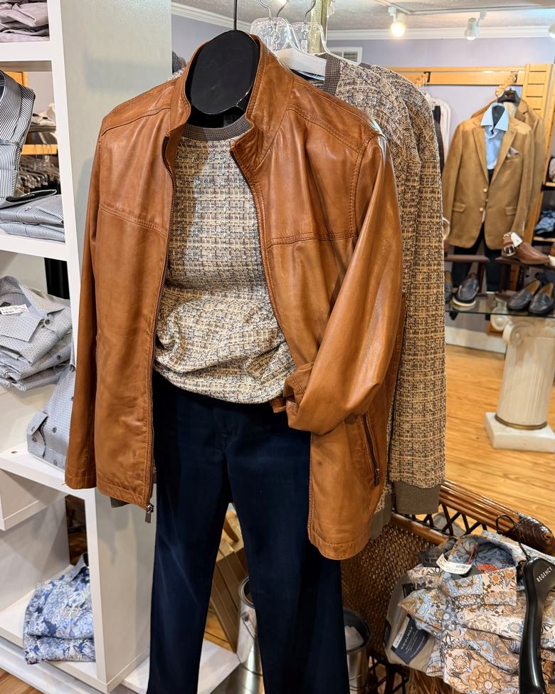 A cognac leather jacket over a textured knit