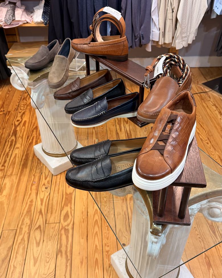 Loafers and sneakers on the glass column table