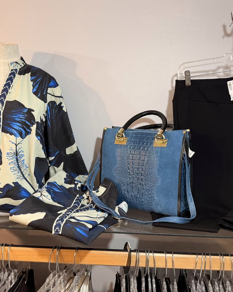 A blue floral blouse with a croc-embossed bag