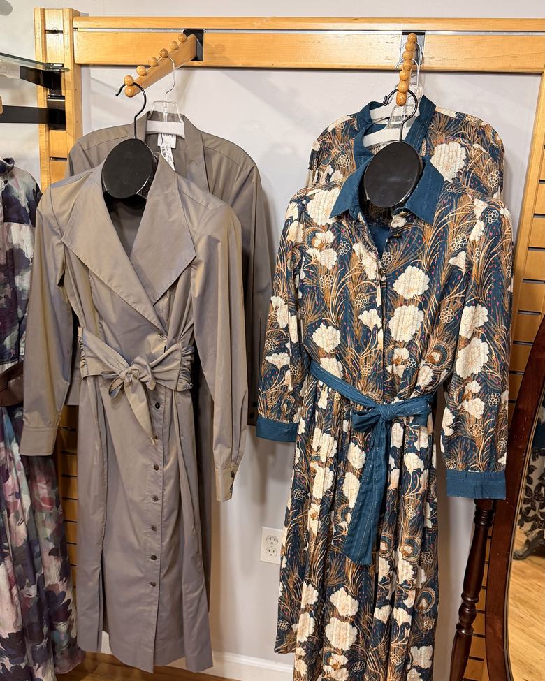 A grey trench dress beside a floral shirt dress