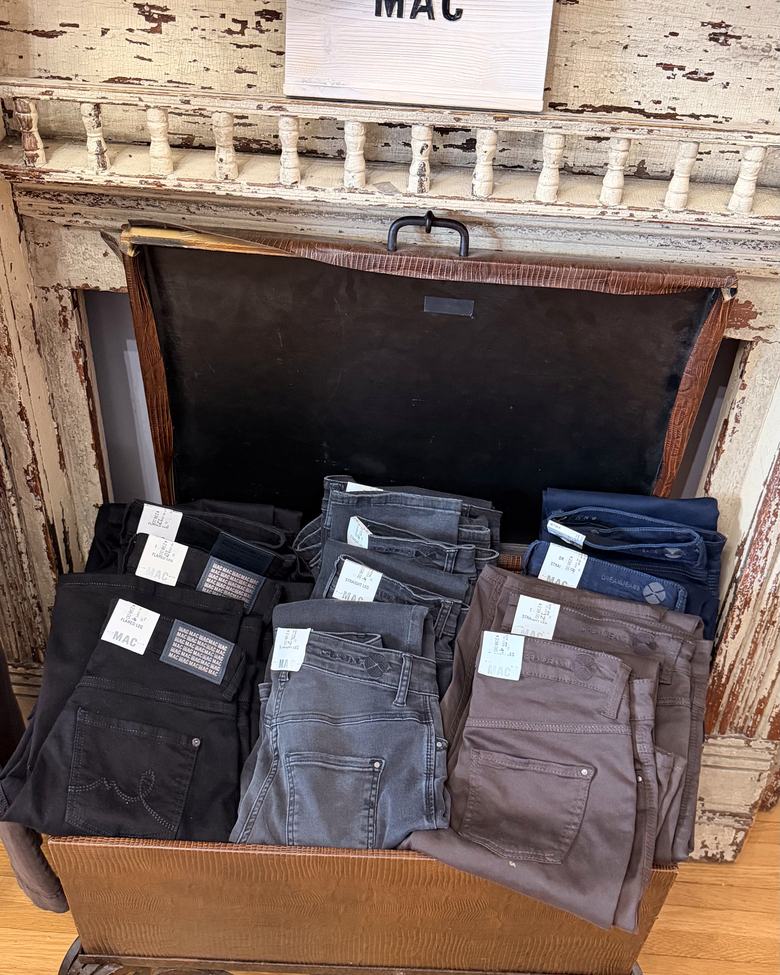 MAC jeans folded in a leather trunk